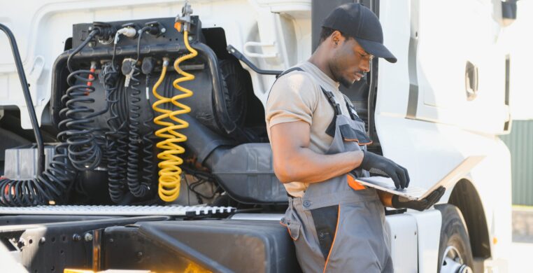 Truck repair service. Mechanic makes computer diagnostic of the semitruck