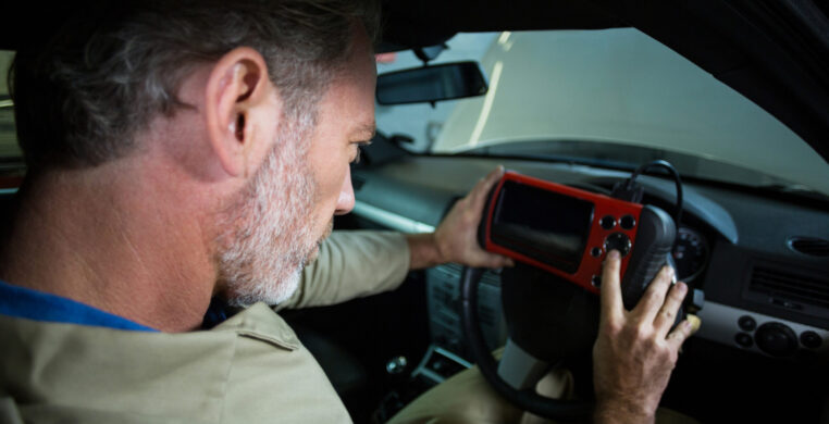 Mechanic using a diagnostic tool at the repair shop