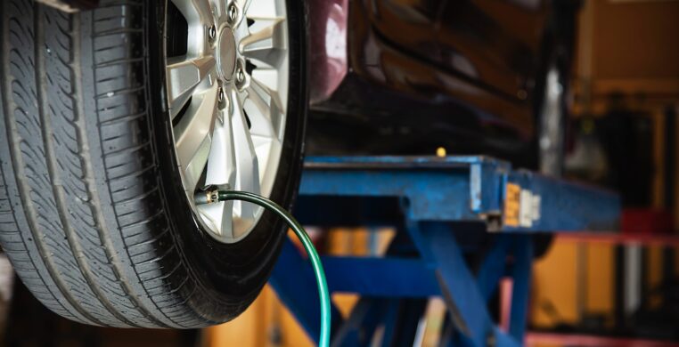 Technician is inflate car tire - car maintenance service transportation safety concept